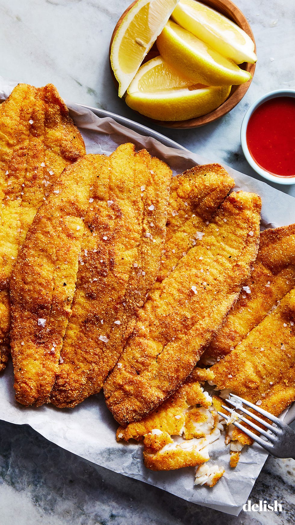 thin white fish coated in a seasoned cornmeal and flour blend, then shallow fried until golden brown and beautiful