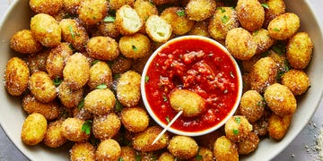 fried gnocchi bites in a bowl with marinara sauce on the side