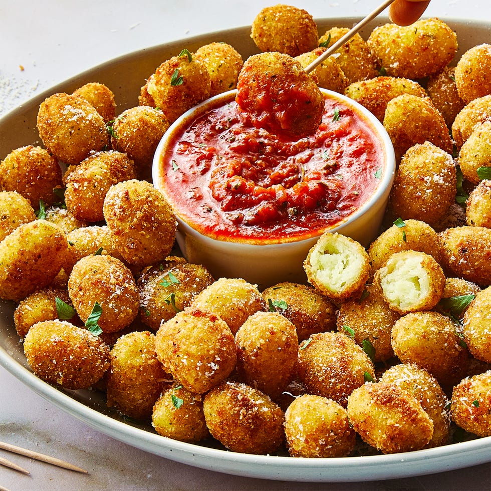 fried gnocchi bites in a bowl with marinara sauce on the side