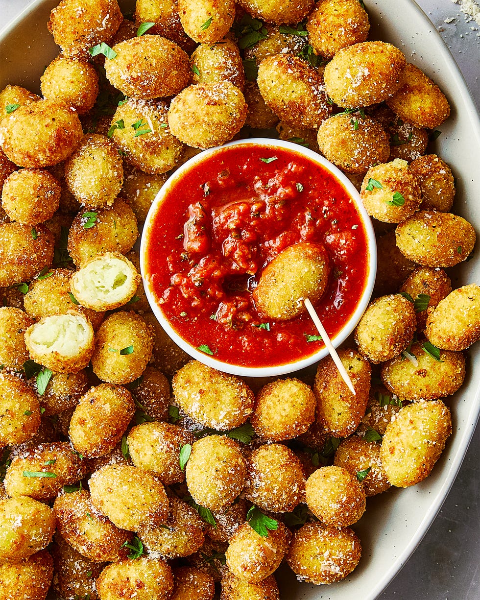 fried gnocchi bites in a bowl with marinara sauce on the side