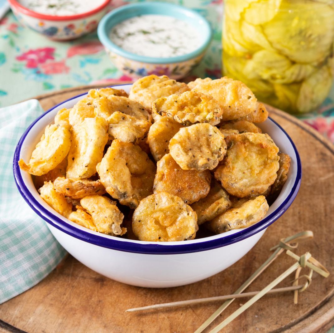 fried pickles in white bowl with blue trim