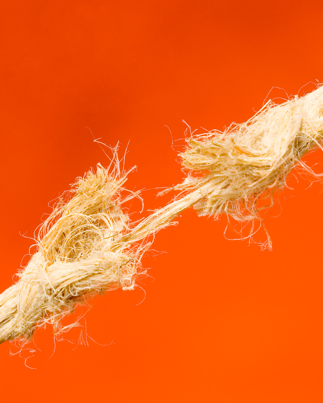 rope breaking on orange background