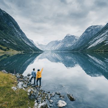 friends admiring the view on the banks of a norwegian fjord, norway