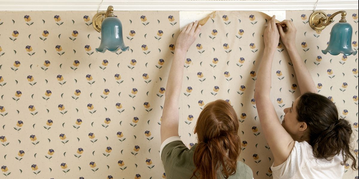 two girls removing wall paper