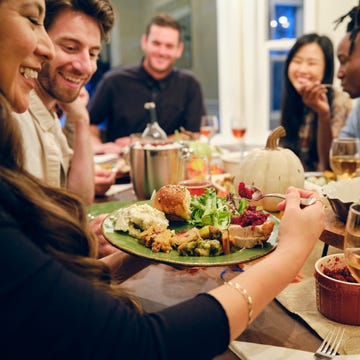 Friends Celebrating Thanksgiving Dinner Together friends celebrating thanksgiving dinner together