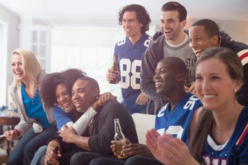 friends drinking beer and watching game on television