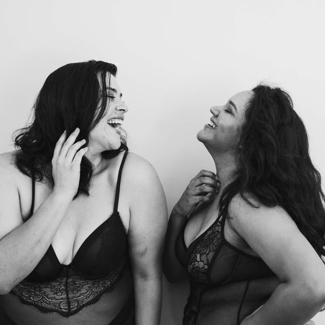 friends in lingerie posing indoors against grey background