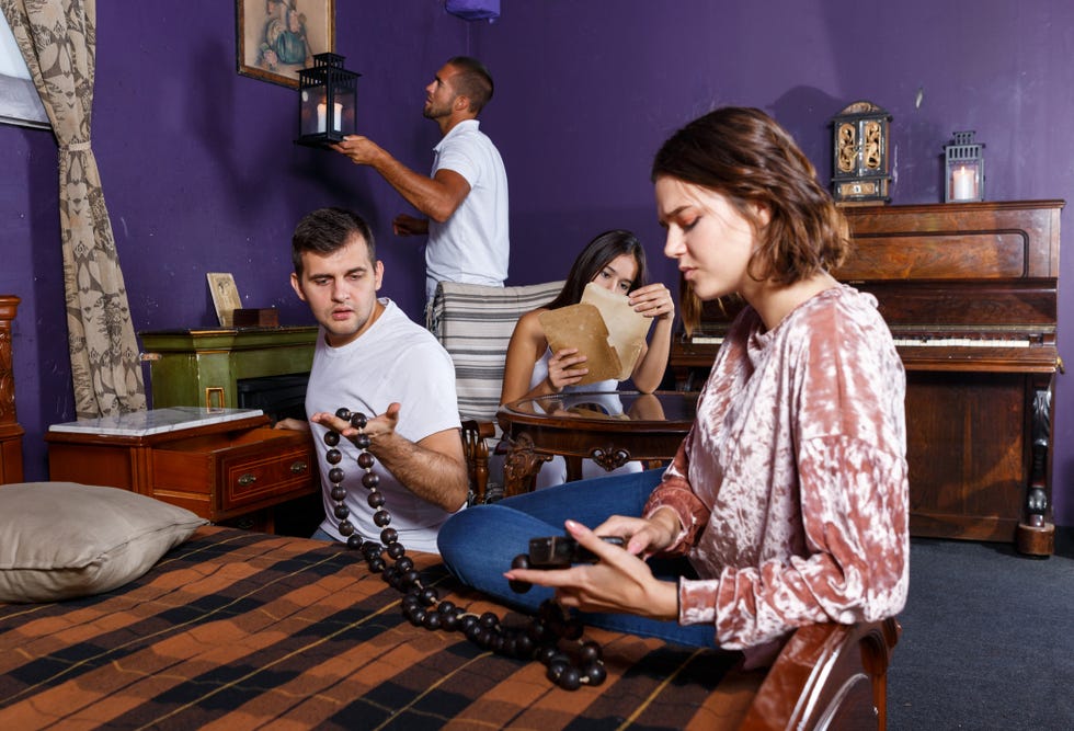 friends looking at wooden rosary in quest room