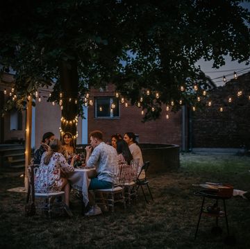 friends on dinner party in back yard