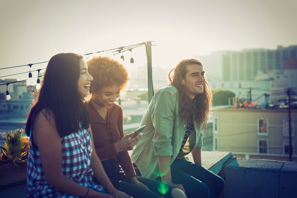 friends sharing a laugh on urban rooftop