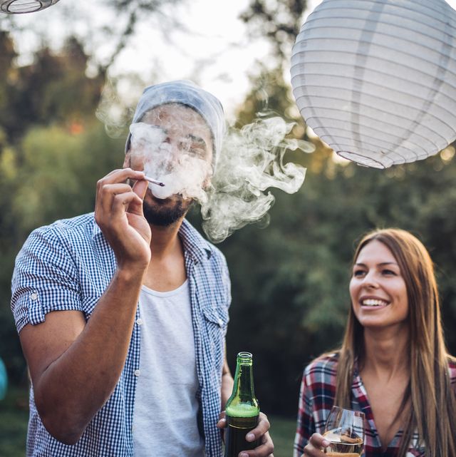 Friends smoking and drinking at a party
