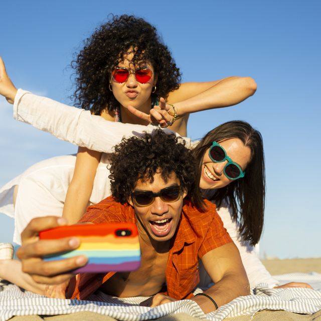 friends taking a selfie with at the beach