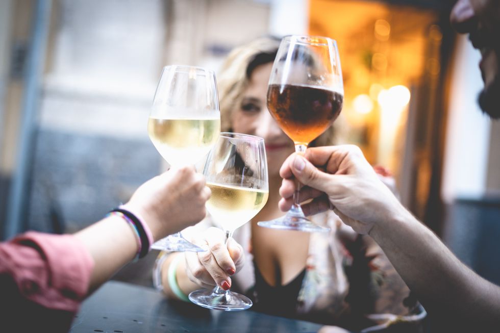 friends toasting wineglasses on table