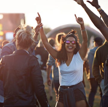 Friends with arms in the air at festival concert