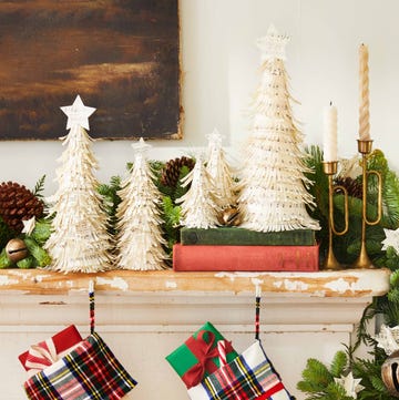 mantel with christmas decor including stockings and foam cones with overlapping layers of shredded sheet music christmas decor holiday party