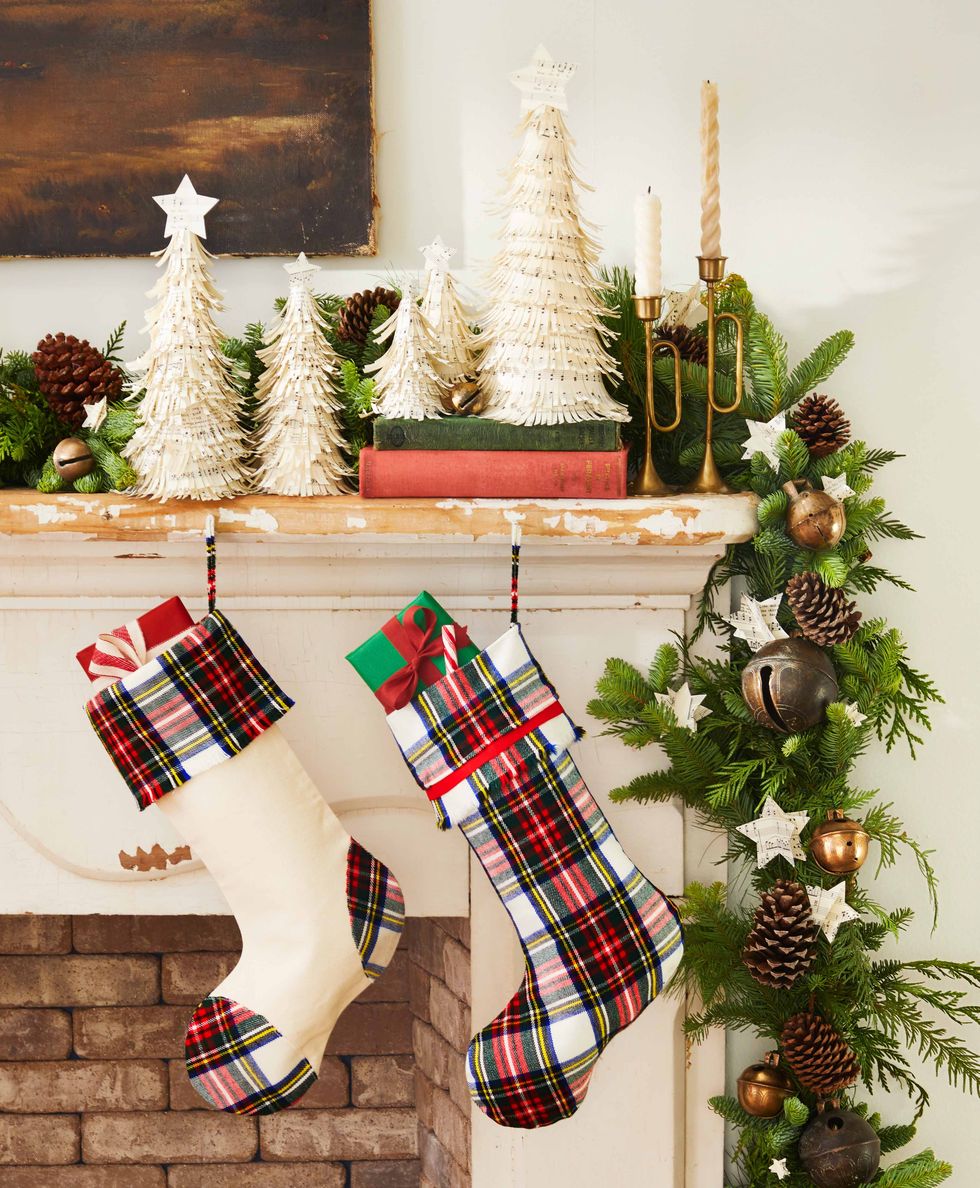 Mantel with Christmas decorations. Includes stockings and foam cone with layers of shredded sheet music. Christmas decoration holiday party.
