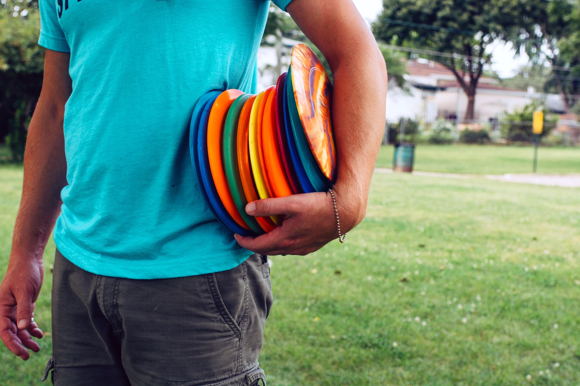 person holding frisbee golf discs