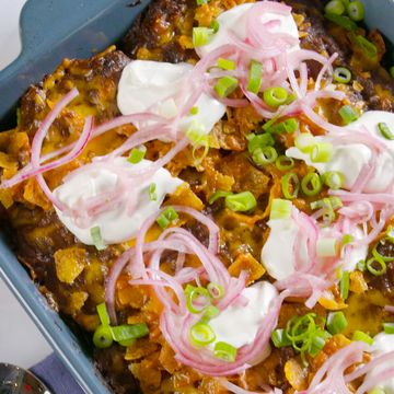 frito lasagna with sour cream, pickled onions and cheddar