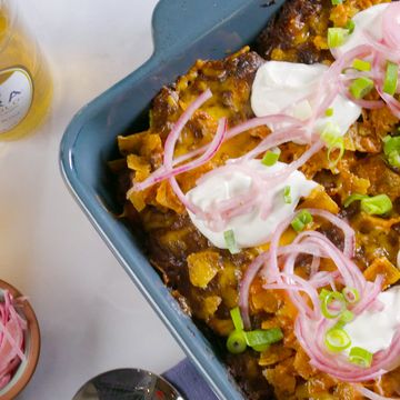 frito lasgana with sour cream, pickled onions and cheddar