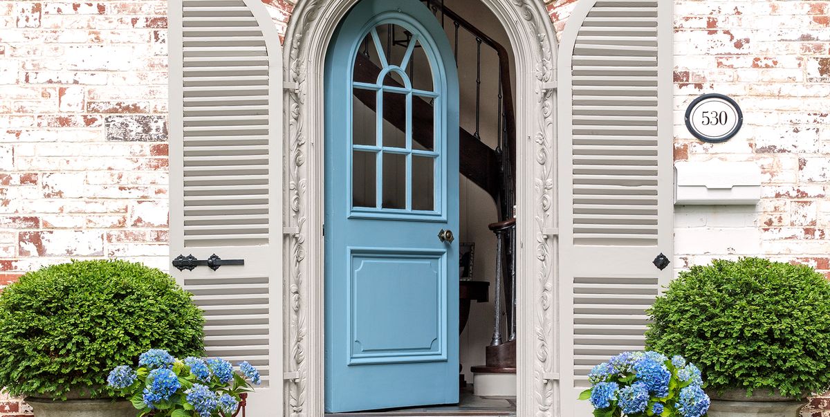 light blue front door with brick home