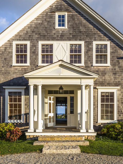 19th century farm in block island, rhode island designed by miles redd and gil schafer the shingle style home’s entrance affords a view straight through to the water the trim is painted white dove by benjamin moore