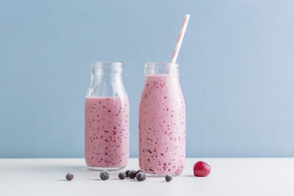 front view pink smoothie bottles with blueberries