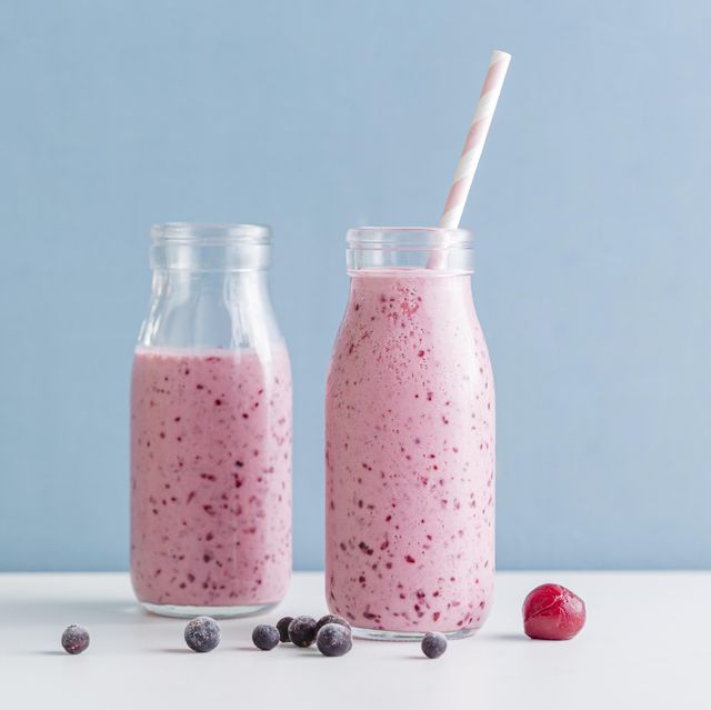https://hips.hearstapps.com/hmg-prod/images/front-view-pink-smoothie-bottles-with-blueberries-royalty-free-image-1702503338.jpg?crop=0.668xw:1.00xh;0.138xw,0&resize=640:*