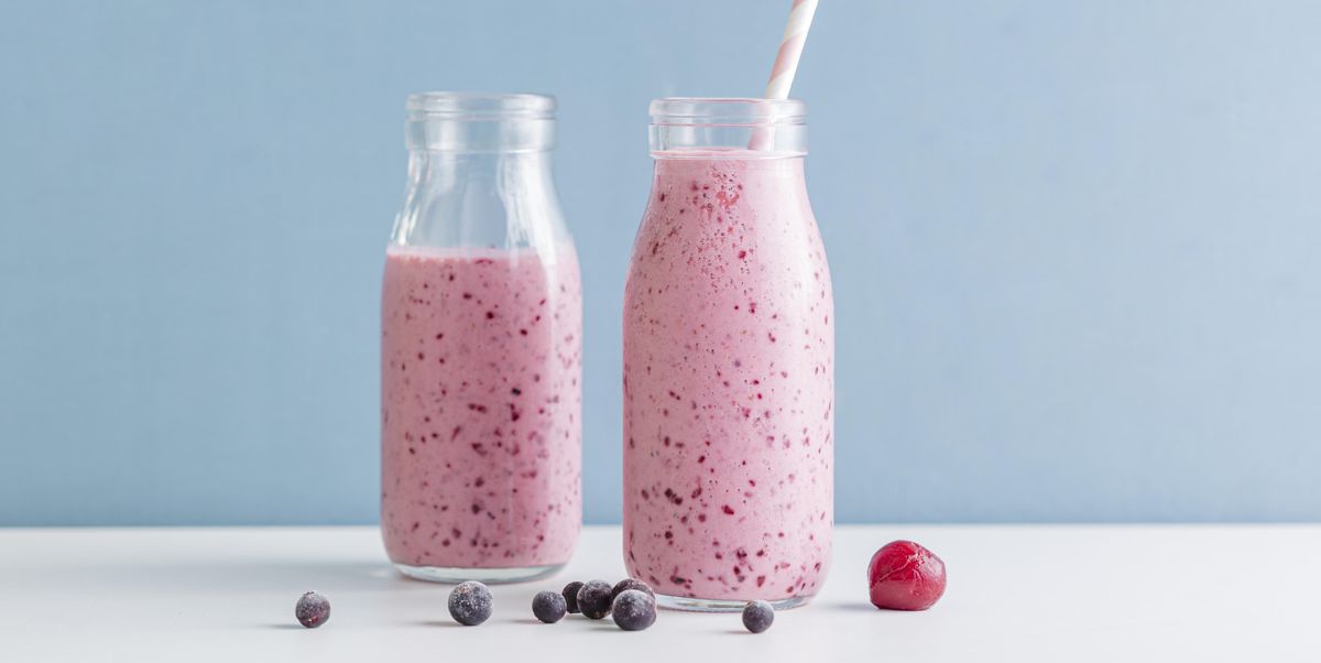 https://hips.hearstapps.com/hmg-prod/images/front-view-pink-smoothie-bottles-with-blueberries-royalty-free-image-1702503338.jpg?crop=1.00xw:0.752xh;0,0.209xh&resize=1200:*