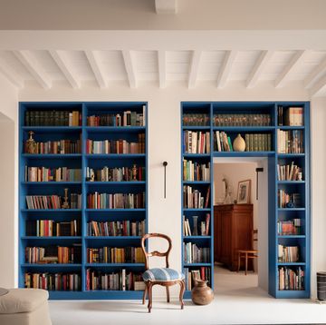 a room with a bookcase and a chair