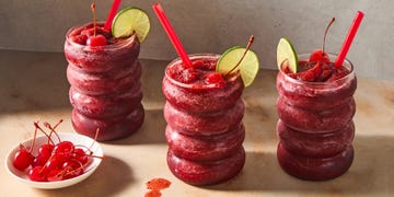 cherry coke blended frozen slushies topped with a lime wedge and maraschino cherry