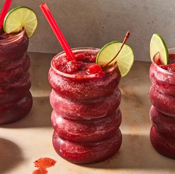 cherry coke blended frozen slushies topped with a lime wedge and maraschino cherry