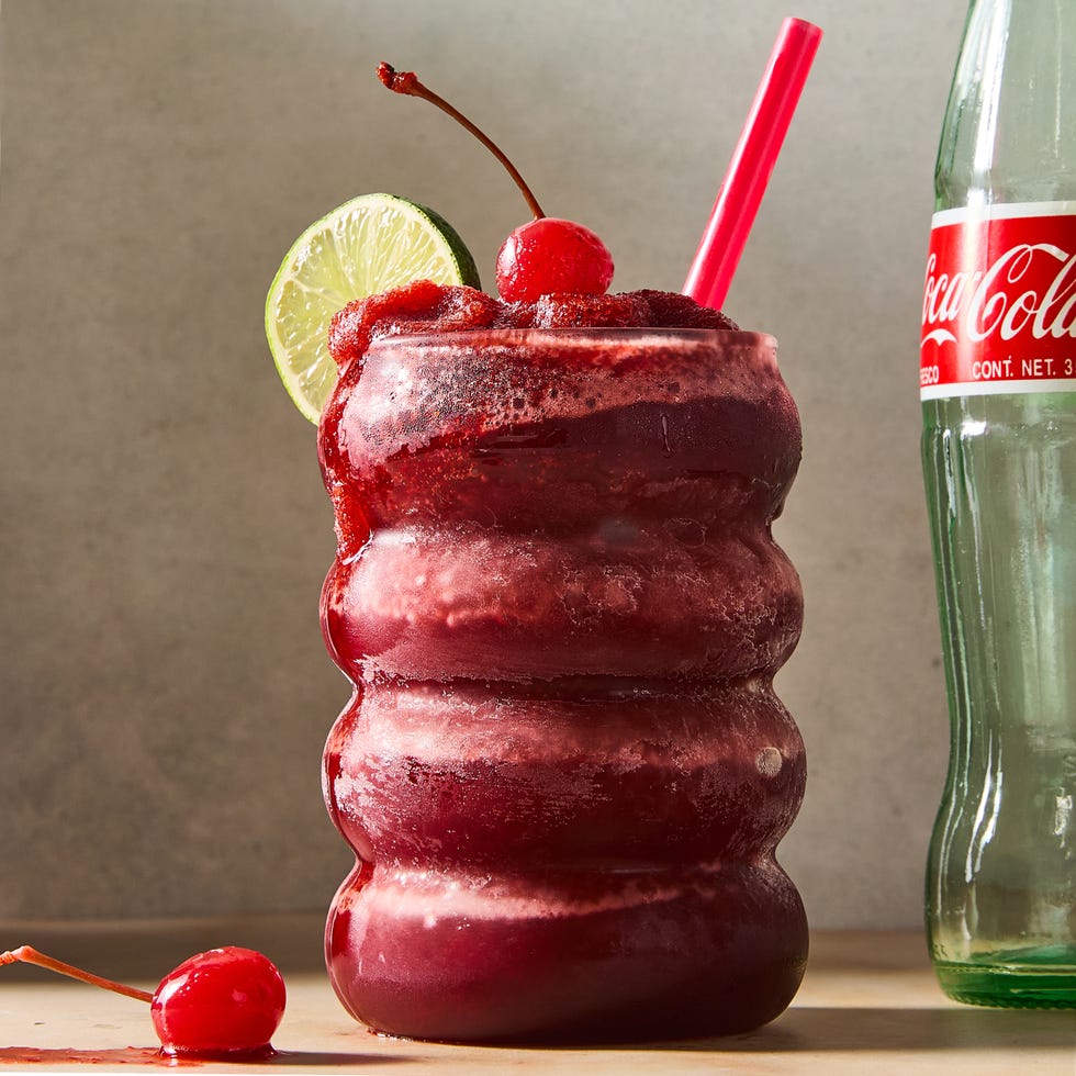 cherry coke blended frozen slushies topped with a lime wedge and maraschino cherry