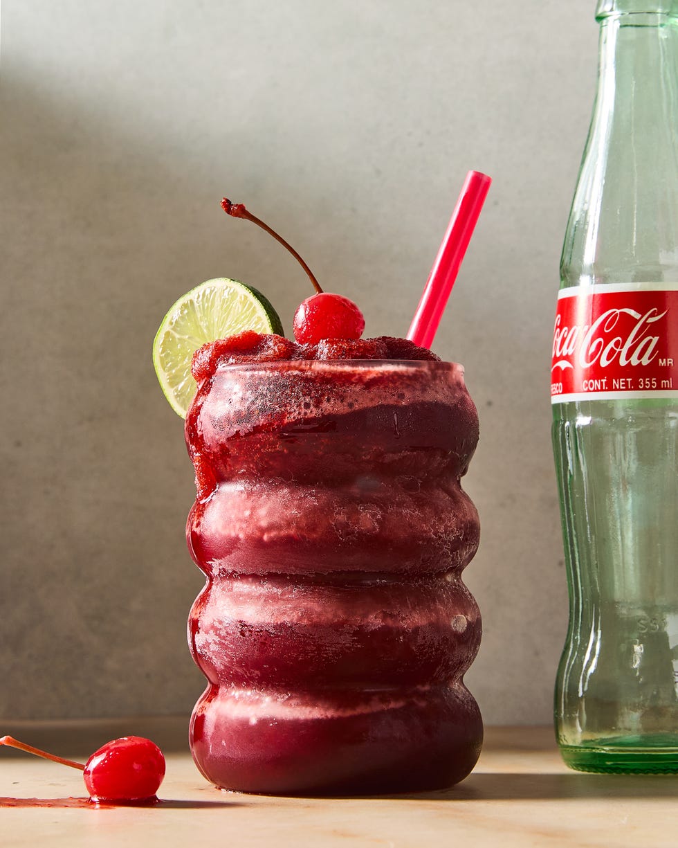 cherry coke blended frozen slushies topped with a lime wedge and maraschino cherry