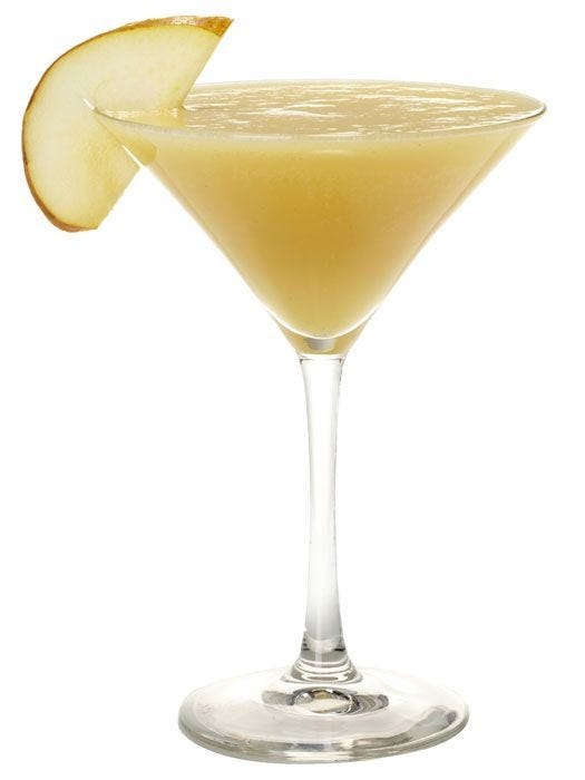 frozen pear slushie in a martini glass with a thin slice of pear as garnish