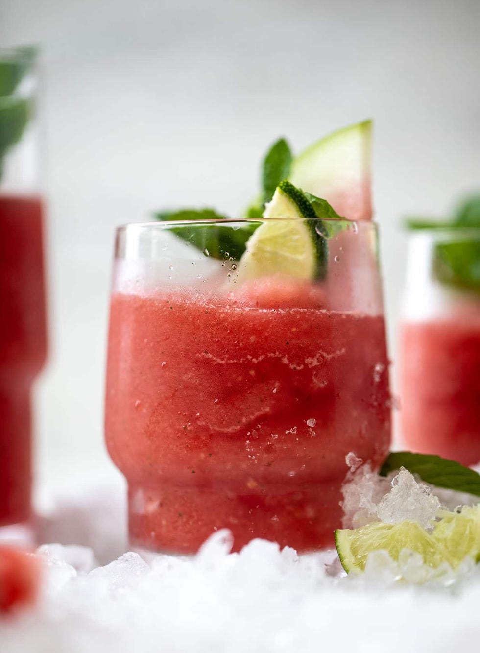 frozen watermelon mojitos with slices of watermelon and limes