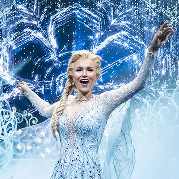 samatha barks as elsa in the frozen west end musical, standing in front of a stylised ice archway with her arms raised