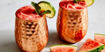 frozen pink watermelon mules in a copper moscow mule cup garnished with mint and a lime wheel