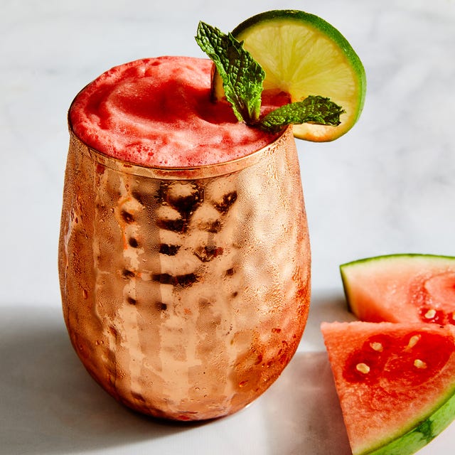 Frozen Watermelon Mules frozen pink watermelon mules in a copper moscow mule cup garnished with mint and a lime wheel