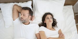 frustrated couple lying in bed