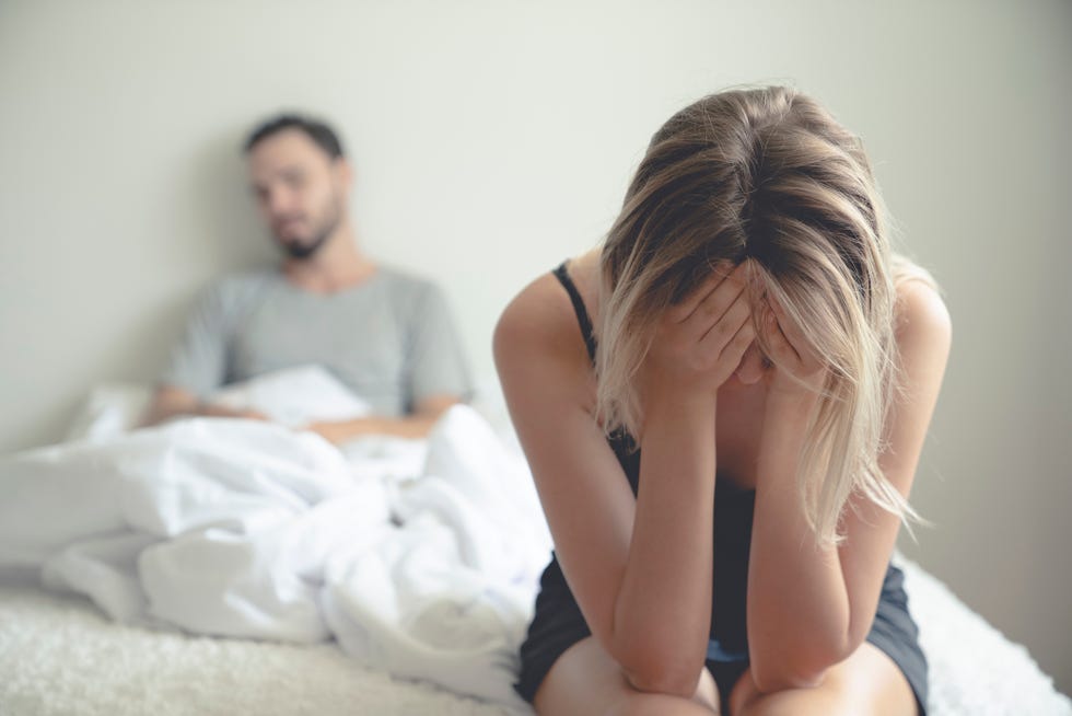 frustrated sad girlfriend sit on bed think of relationship problems