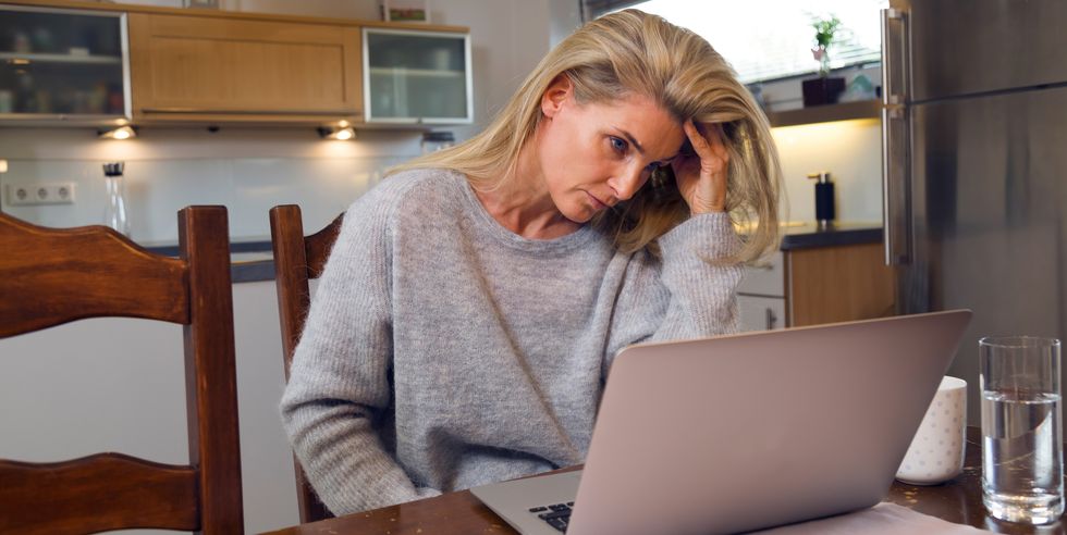 Frustrated Woman Looking In Laptop At Table