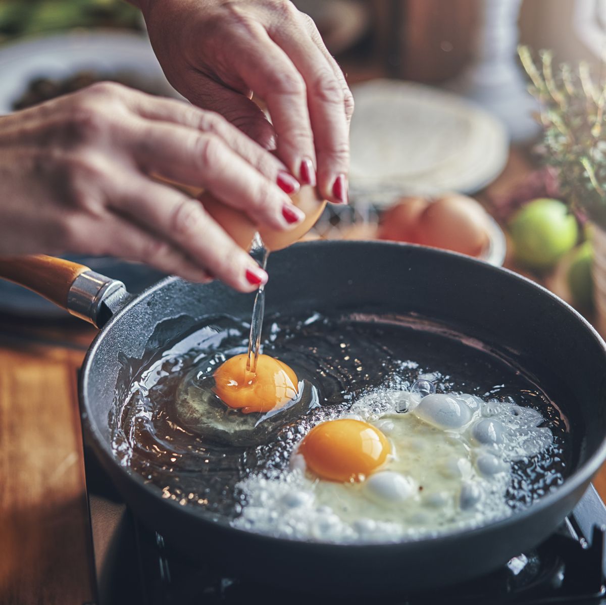 https://hips.hearstapps.com/hmg-prod/images/frying-egg-in-a-cooking-pan-in-domestic-kitchen-royalty-free-image-1129381764-1566925040.jpg?crop=0.668xw:1.00xh;0.167xw,0&resize=1200:*
