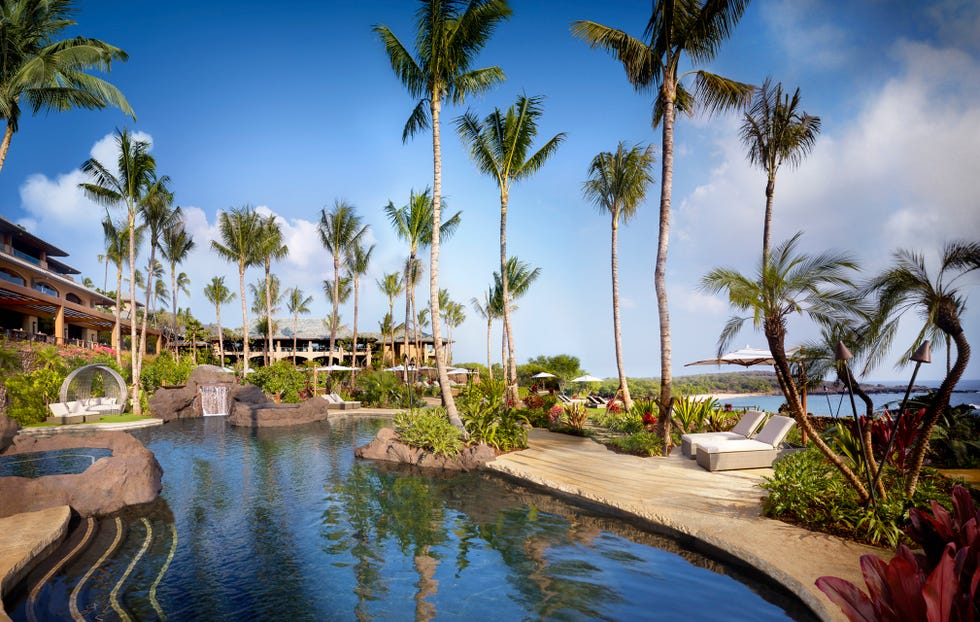 the pool and palm trees at four seasons lanai in hawaii