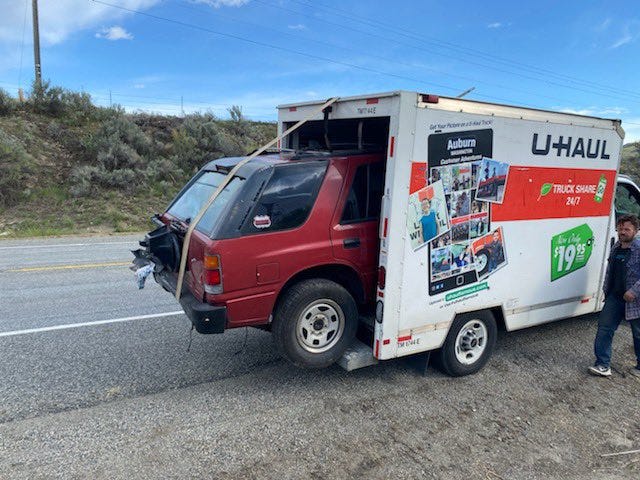 suv hanging out of u haul