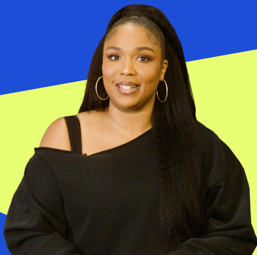 a person wearing a black offshoulder sweatshirt with long hair against a vibrant blue and yellow background a person wearing a black offshoulder sweatshirt with long hair against a vibrant blue and yellow background