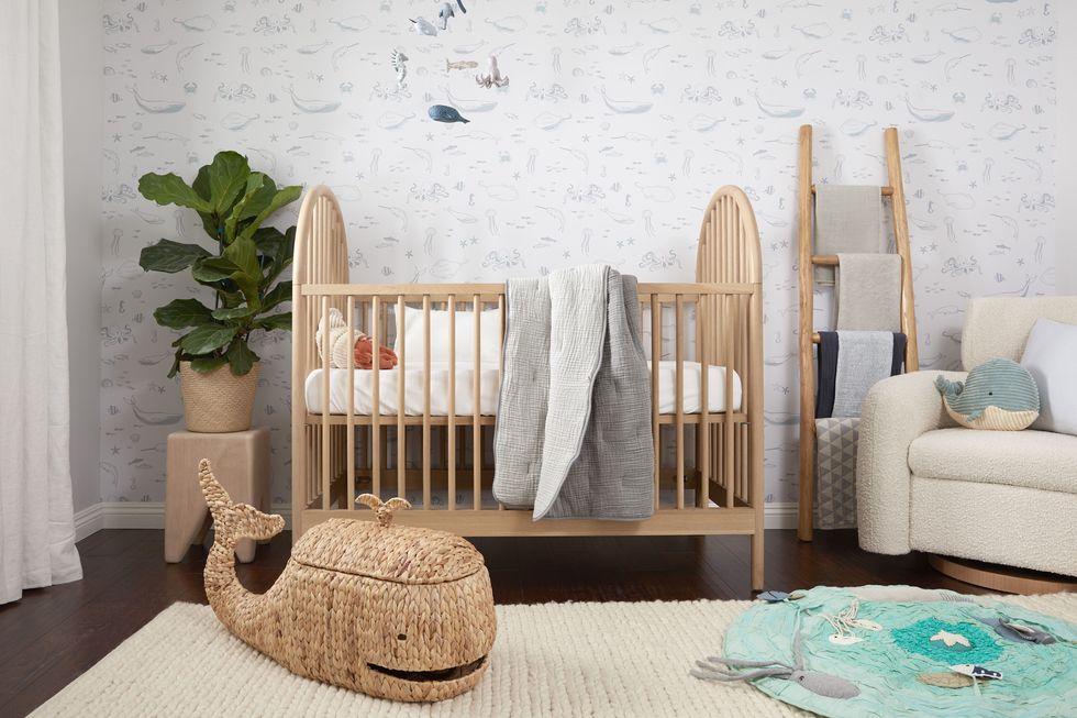 nursery with whale basket and natural wood crib