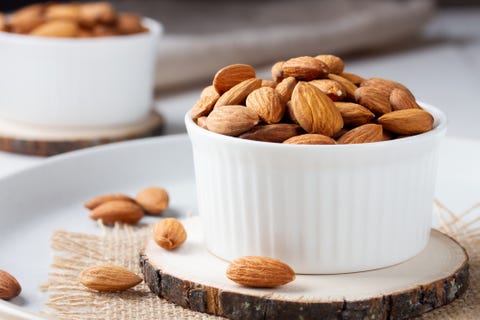 full bowl of almond nuts, rustic style