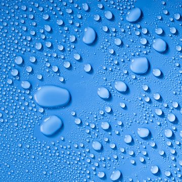 Full frame of the textures formed by the bubbles and drops of water, on a blue color background.
