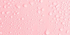 full frame of the textures formed by the bubbles and drops of water, slipping on the crystal of a window of color pale pink