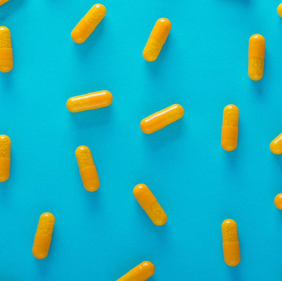 full frame shot of yellow capsules against blue background